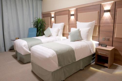 Un pat sau paturi într-o cameră la Sukoon Hotel