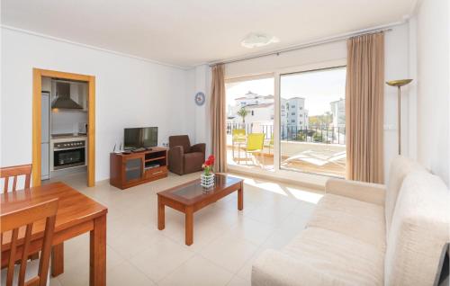 a living room with a couch and a table at 2 Bedroom Amazing Apartment In Roldán in Los Tomases