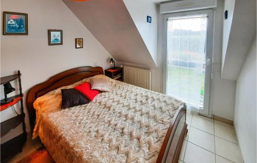 a bedroom with a bed with a large window at Awesome Apartment In Roz-landrieux With Kitchen in Roz-Landrieux
