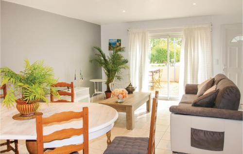 a living room with a couch and a table at Amazing Home In Lançon De Provence in Lançon-Provence