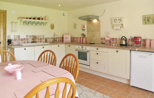 a kitchen with a table and a pink counter top at Stunning Home In Saint-Pierre-Sur-Orth in Sillé-le-Guillaume