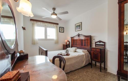 a bedroom with a bed and a desk and a table at Amazing Apartment In Altea With 2 Bedrooms in Altea