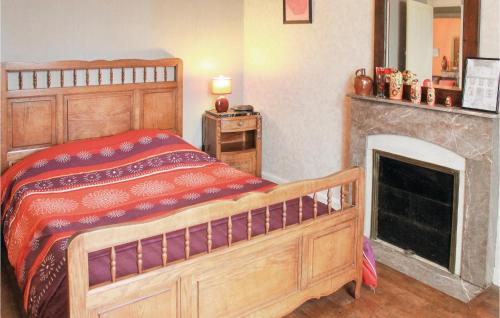 - une chambre avec un lit en bois et une cheminée dans l'établissement Amazing Home In Morlaix With Wifi, à Sainte-Geneviève