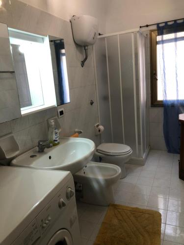 a bathroom with a white sink and a toilet at Soleli in Molino San Biagio