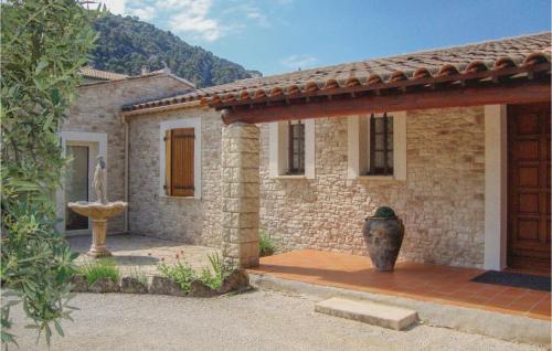 une maison en pierre avec un vase devant elle dans l'établissement La Maoure, à Robion