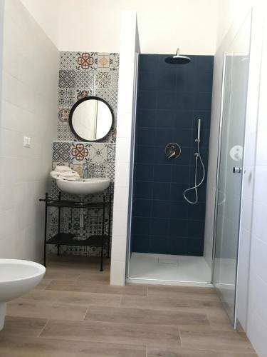 a bathroom with a shower and a sink and a mirror at Casa via Garibaldi in Leverano