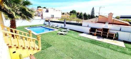 einen großen Garten mit Pool auf einem Haus in der Unterkunft Agradable Villa con Piscina y BBQ. in San Vicente del Raspeig