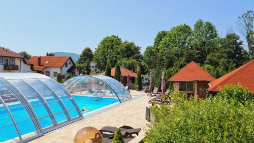 a large outdoor pool with a large blue umbrella at SEDRA Holiday Resort-Adults Only in Grabovac