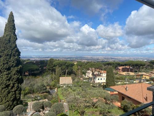a view of a village with a tree at “Casa Amélie” in Grottaferrata