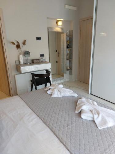 a bedroom with a bed with towels on the floor at ELITE LUXURY APARTMENTS in Argostoli