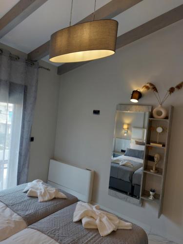 a bedroom with a bed and a mirror at ELITE LUXURY APARTMENTS in Argostoli