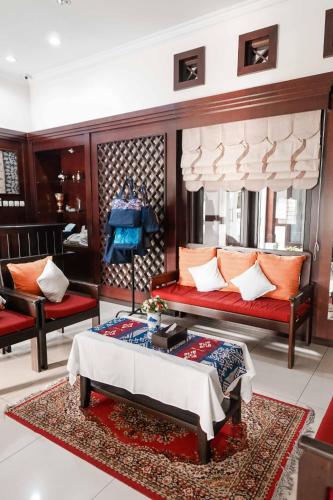 a bedroom with a bed and a table and chairs at Pasola Guest House in Medan