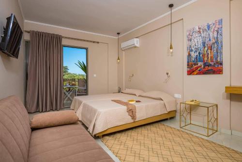 a bedroom with a bed and a couch at Nissi Collection Rooms in Argassi