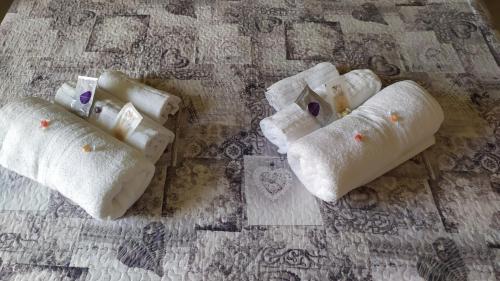 three towels are sitting on a tile floor at LA TANA DELLA VOLPE in La Spezia