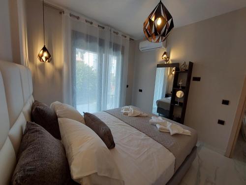 a bedroom with a large bed and a window at ELITE LUXURY APARTMENTS in Argostoli