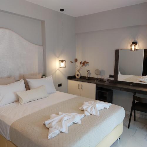 a bedroom with a bed with white towels on it at ELITE LUXURY APARTMENTS in Argostoli