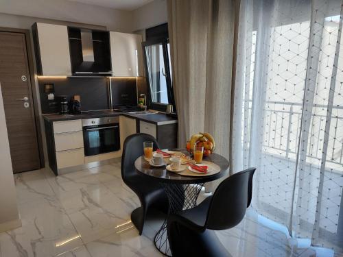 a living room with a table and chairs and a kitchen at ELITE LUXURY APARTMENTS in Argostoli