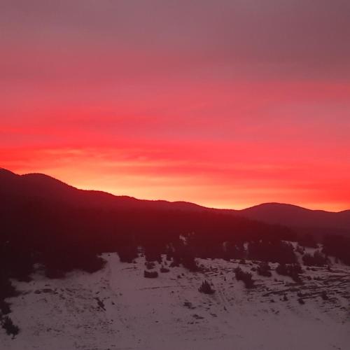 a sunset in the mountains with a red sky at Айрови in Sarnitsa