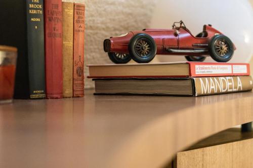 a toy car sitting on top of a book at Torre Granitola Suite in Granitola