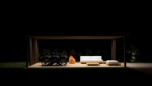 a stage with a white couch and chairs on it at Torre Granitola Suite in Granitola