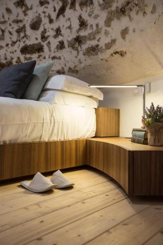 a bedroom with a bed and a wooden floor at Torre Granitola Suite in Granitola