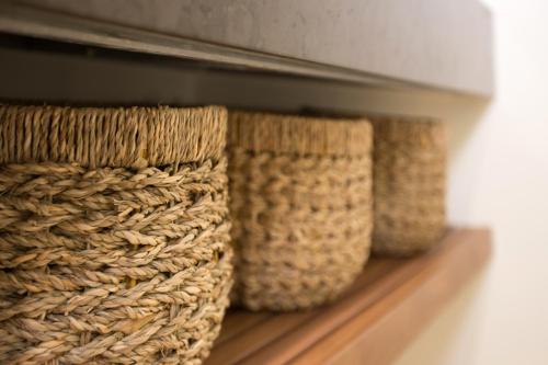a row of baskets sitting on a shelf at Torre Granitola Suite in Granitola