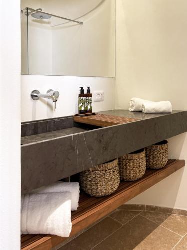 a bathroom with a sink and a mirror at Torre Granitola Suite in Granitola