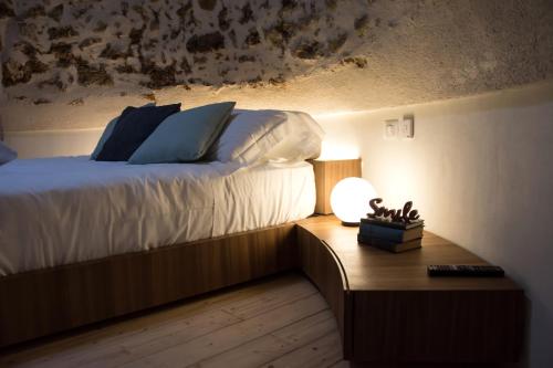 a bedroom with a bed and a table with a lamp at Torre Granitola Suite in Granitola