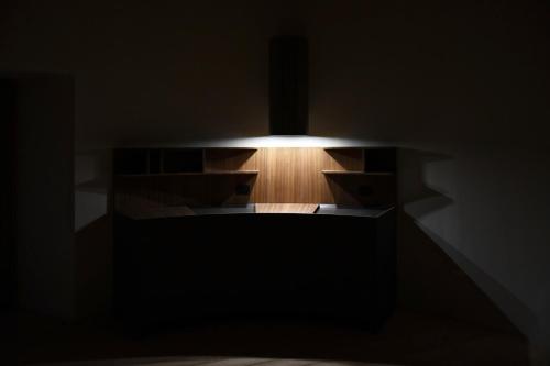 a dark room with a light in the middle at Torre Granitola Suite in Granitola