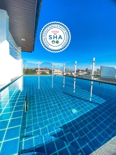 a swimming pool on the roof of a building at DE LUXE BOUTIQUE & rooftop in Chiang Mai