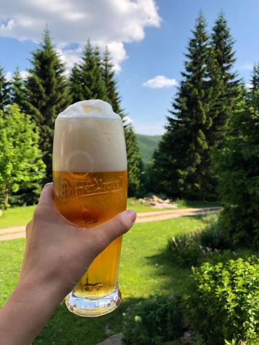 a person holding up a glass of beer at Horská bouda U Kokrháče in Dolní Malá Úpa