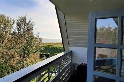 a balcony with a window and a view of a field at Havudsigt Ferielejlighed in Dannemare