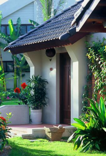 a small house with a door in a yard at Palm Garden Beach Resort & Spa in Hoi An