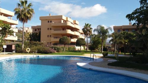 a swimming pool in front of a apartment building at Málaga, Mijas, La Cala, apartamento vacaciones de ensueño in La Cala de Mijas