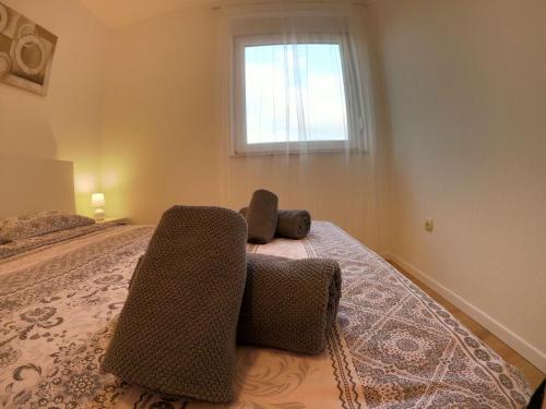 a bedroom with a bed with two chairs on it at Apartment Gloria in Peroj