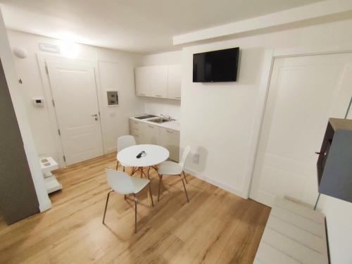 a small kitchen with a table and chairs in a room at City Gallery Apartments in Trieste