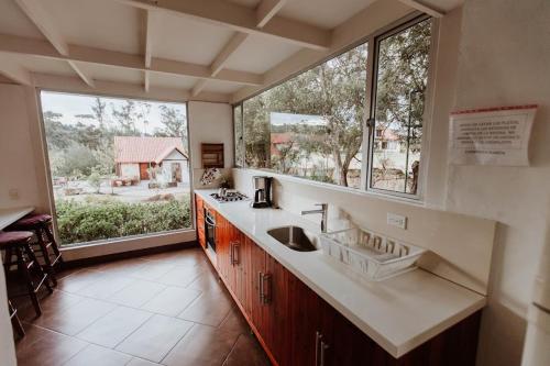 a kitchen with a sink and a large window at Chalet Andino Sesquile in Suesca
