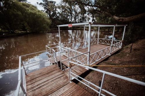 a boat on a river with a dock at Chalet Andino Sesquile in Suesca