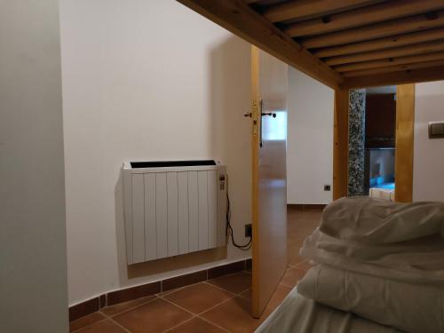 a room with a heater in the corner of a room at Apartment in Llavorsi in the heart of the Catalan Pyrenees in Llavorsí