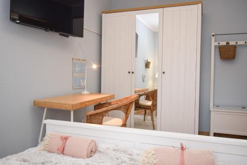 a bedroom with a bed and a desk and a mirror at Apartament Maciej in Żary