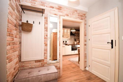 a brick wall in a kitchen with a door at Apartament Maciej in Żary