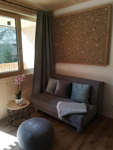 a living room with a couch and a window at Apartment Almwiesen Mellau in Mellau