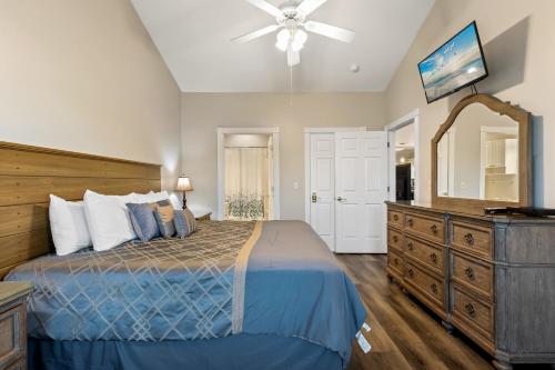 a bedroom with a bed and a dresser with a mirror at Beach at the Greens in Myrtle Beach