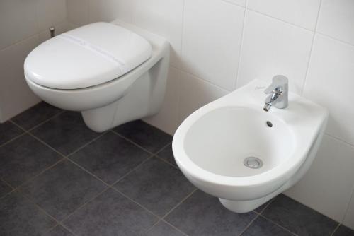 a white toilet and a bidet in a bathroom at Griante suites in Griante Cadenabbia