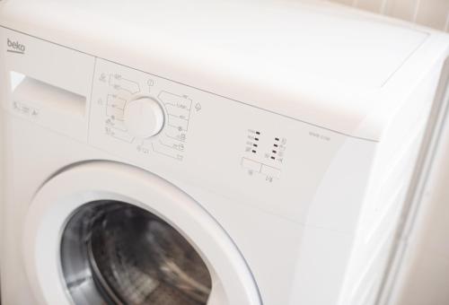 a washing machine in a laundry room at Griante suites in Griante Cadenabbia