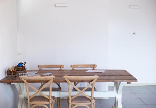 a kitchen with a wooden table and chairs at Griante suites in Griante Cadenabbia