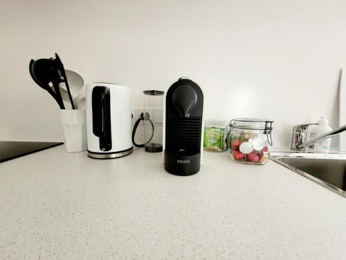 a black appliance sitting on a counter in a kitchen at Apartment Sonnenschein in Dornbirn