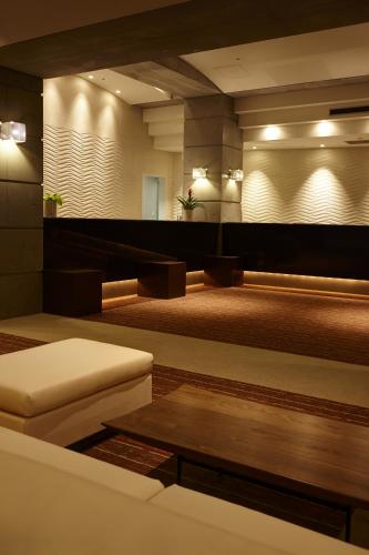 a living room with a couch and a table at The Residential Suites Fukuoka in Fukuoka