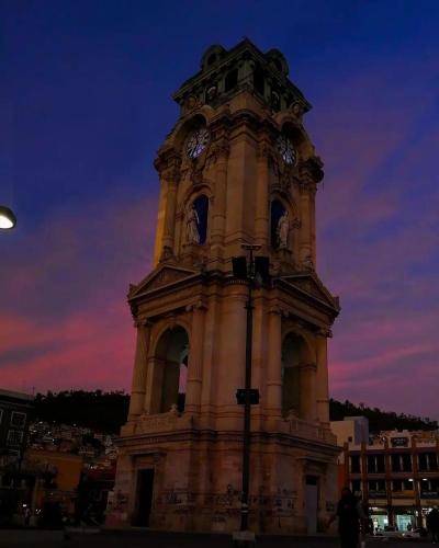a tall tower with a clock on top of it at Hotel de los baños in Pachuca de Soto