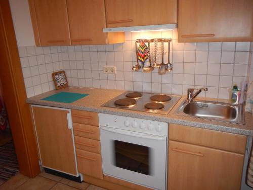 a kitchen with a sink and a stove top oven at Haus Friedburg in Velden am Wörthersee
